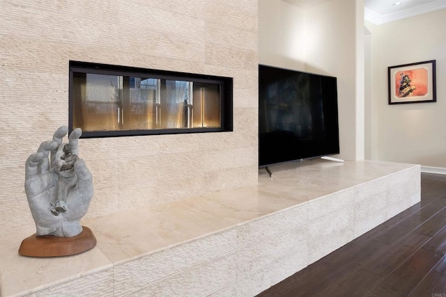 interior details featuring hardwood / wood-style flooring and crown molding