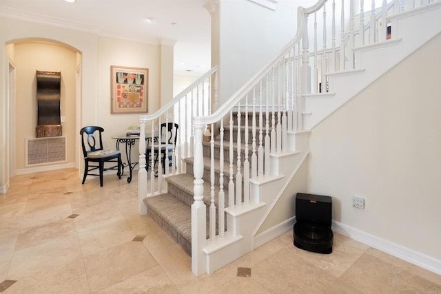 stairway featuring crown molding