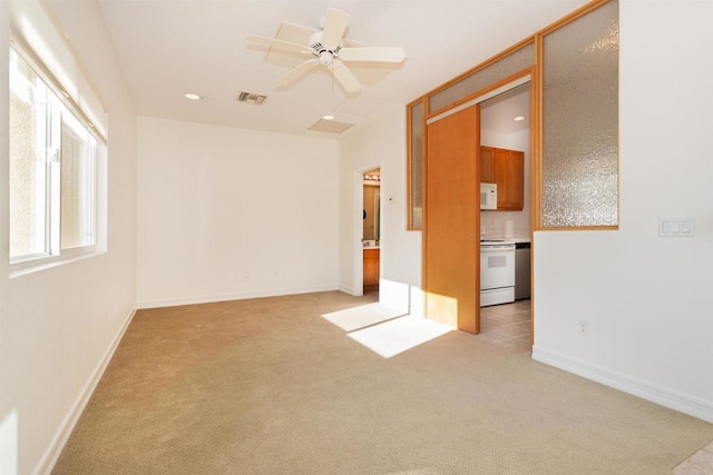 spare room featuring visible vents, light carpet, a ceiling fan, recessed lighting, and baseboards