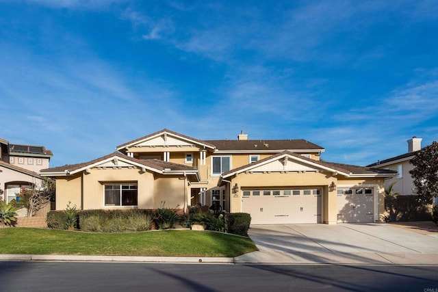 view of front of property with stucco siding, concrete driveway, a garage, and a front yard