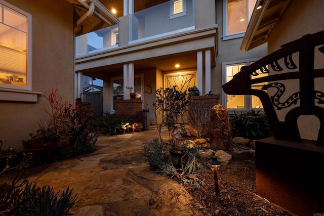 doorway to property featuring stucco siding