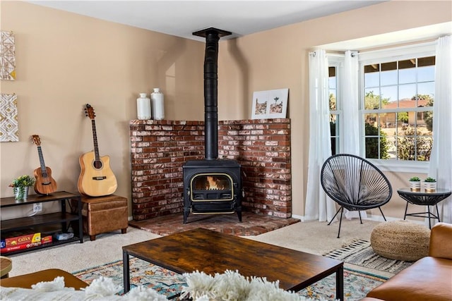 living room with carpet and a wood stove