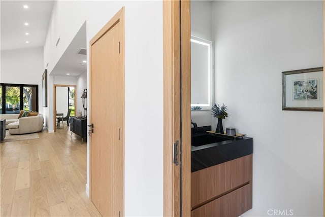 hallway featuring recessed lighting and light wood-style flooring