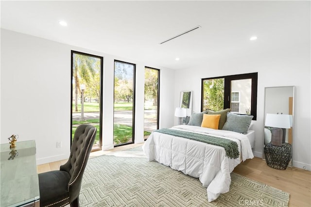 bedroom with recessed lighting and light wood-style flooring