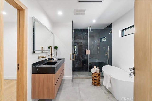 bathroom with double vanity, a stall shower, visible vents, recessed lighting, and a freestanding tub