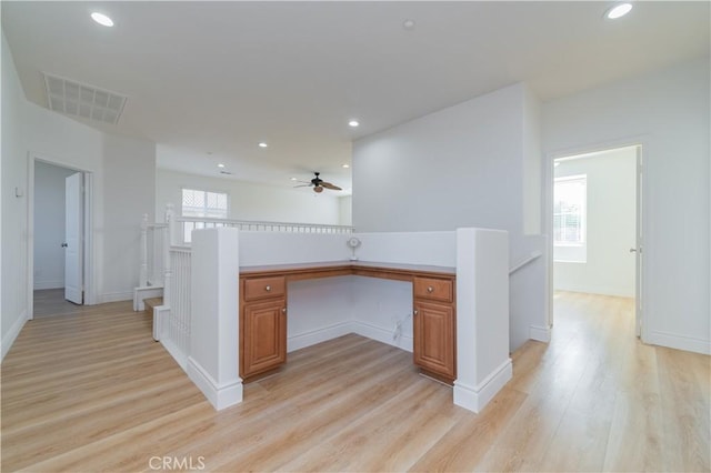 interior space featuring light wood-type flooring and built in desk