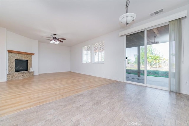 unfurnished living room with ceiling fan and light wood-type flooring