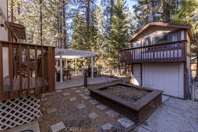 view of patio / terrace featuring a fire pit, a wooden deck, and a pergola