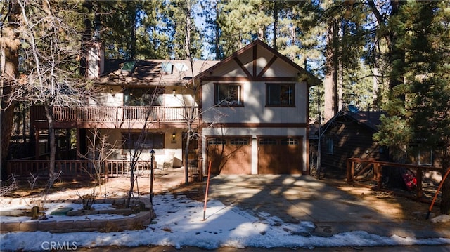 41984 Mapleleaf Dr, Big Bear Lake, CA 92315 - view of front of home with an attached garage, a balcony, and driveway