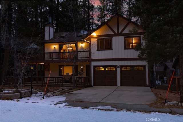 view of front of property featuring a garage and a balcony