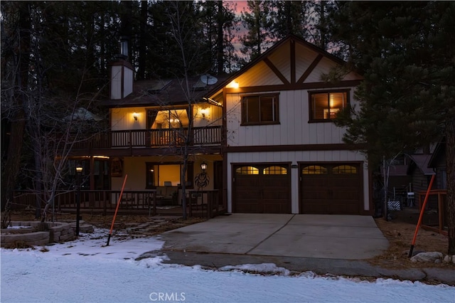 41984 Mapleleaf Dr, Big Bear Lake, CA 92315 - view of front of home with an attached garage, driveway, a balcony, and a porch