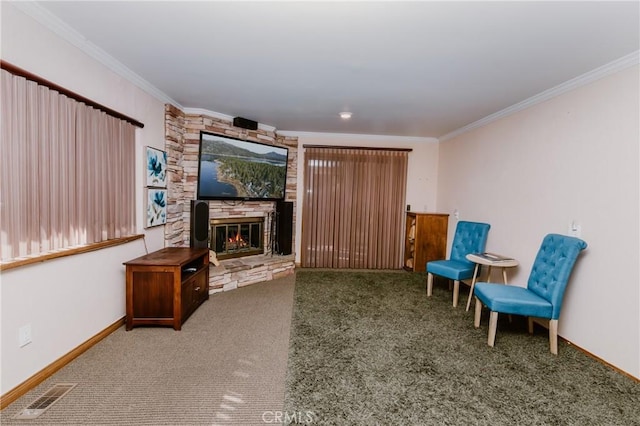 living area featuring crown molding, a fireplace, and carpet