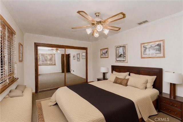 bedroom featuring a closet, ceiling fan, and crown molding