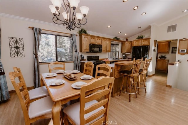 dining space featuring light hardwood / wood-style flooring, vaulted ceiling, sink, a notable chandelier, and ornamental molding