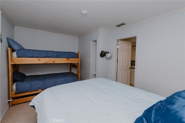 carpeted bedroom with ornamental molding