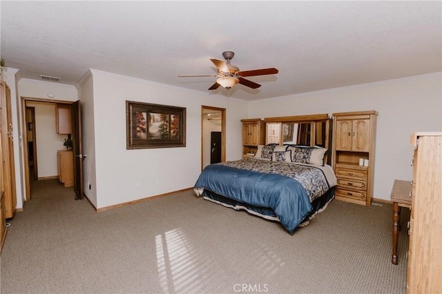 carpeted bedroom with ceiling fan and ornamental molding