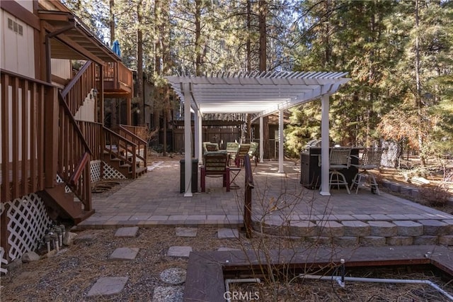 41984 Mapleleaf Dr, Big Bear Lake, CA 92315 - view of patio / terrace with stairway, a pergola, and outdoor dining space