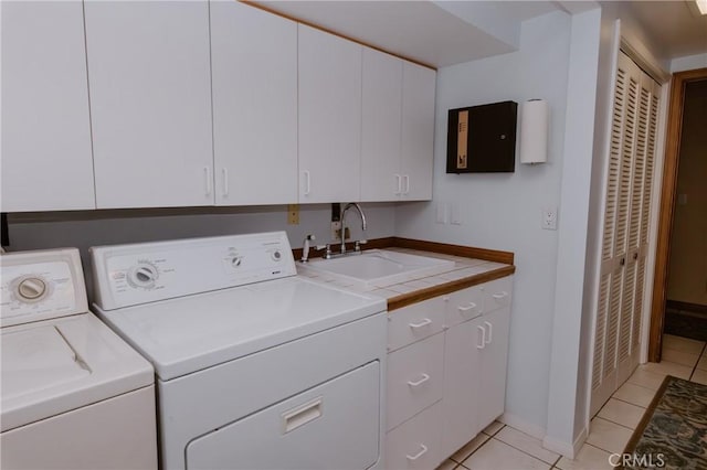 41984 Mapleleaf Dr, Big Bear Lake, CA 92315 - laundry area with washing machine and clothes dryer, cabinet space, light tile patterned flooring, and baseboards
