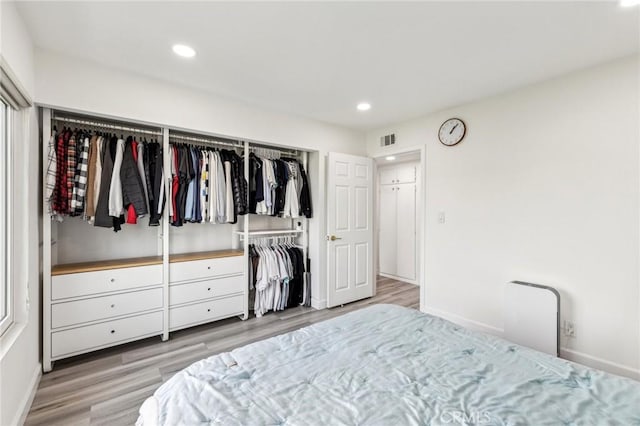 bedroom featuring light hardwood / wood-style floors and a closet