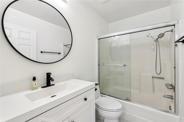 full bathroom featuring enclosed tub / shower combo, vanity, and toilet