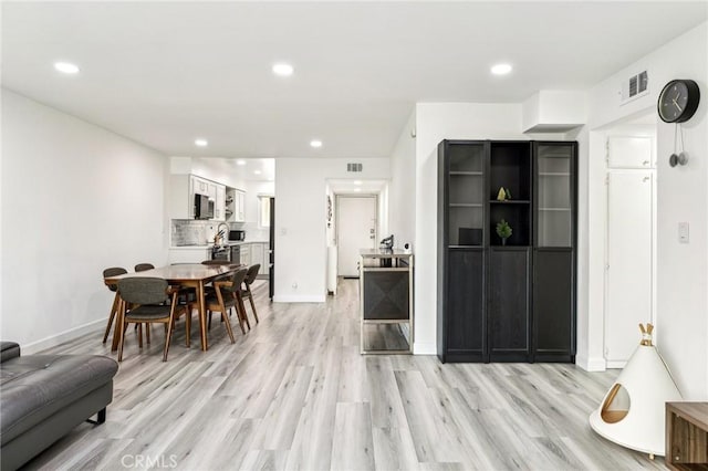 dining room with light hardwood / wood-style flooring