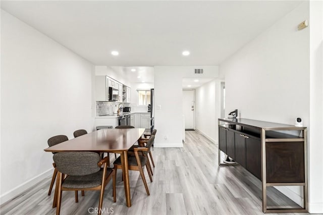 dining room with light wood-type flooring