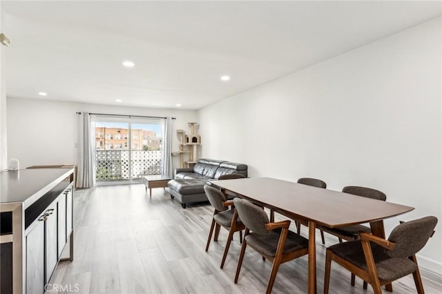 dining space with light hardwood / wood-style flooring