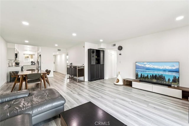 living room with light hardwood / wood-style flooring