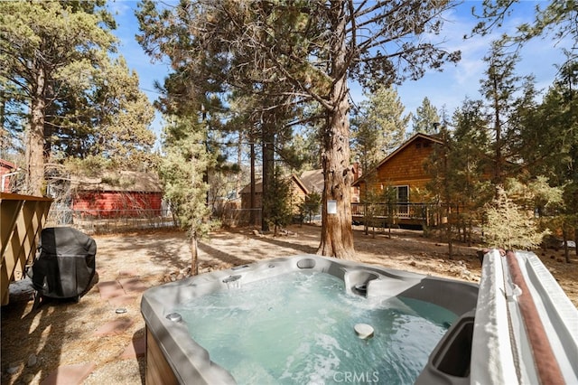 view of yard featuring a hot tub and a deck