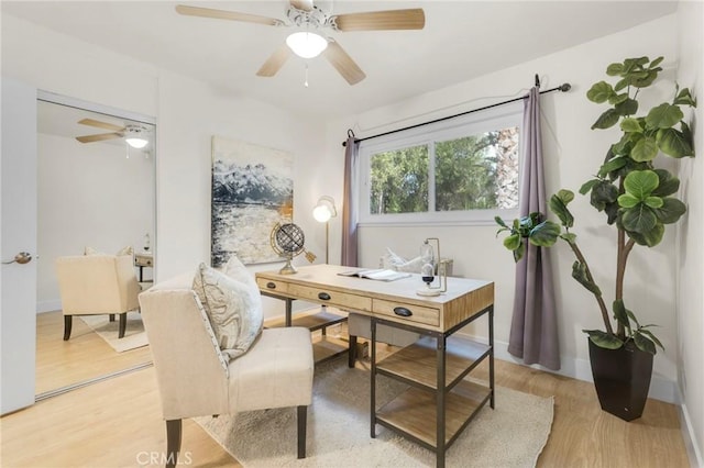 home office featuring light wood-type flooring and ceiling fan