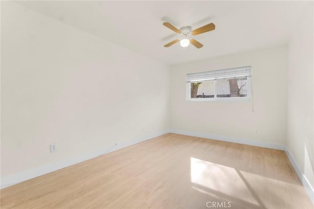 unfurnished room with ceiling fan and hardwood / wood-style floors