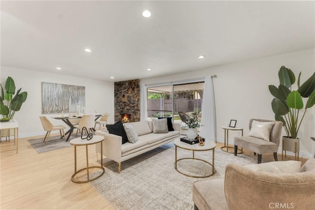 living room with light hardwood / wood-style floors and a fireplace