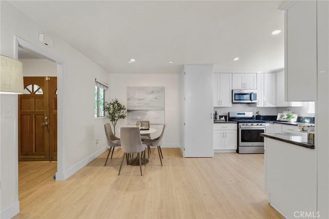 kitchen featuring light wood-type flooring, white cabinetry, and appliances with stainless steel finishes