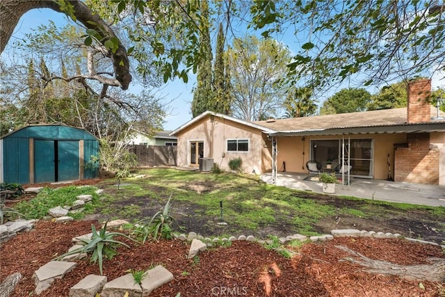 view of yard with a patio, a shed, and central AC unit