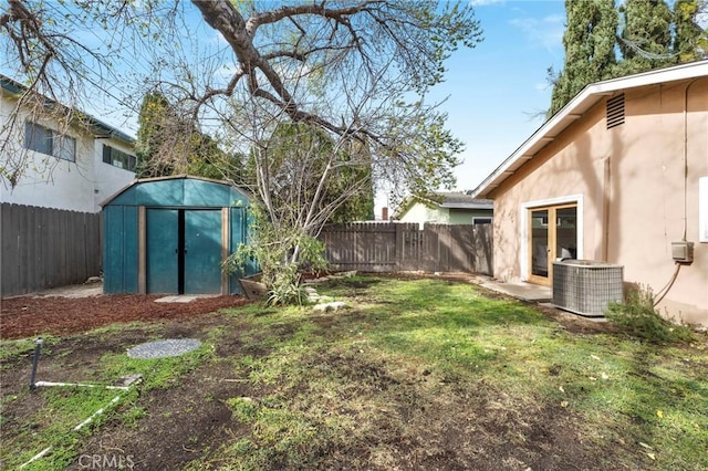 view of yard featuring central AC unit and a storage unit