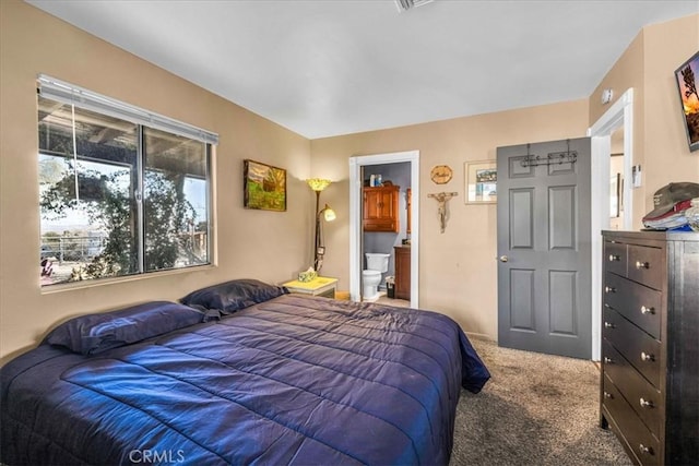 bedroom with carpet floors and ensuite bath