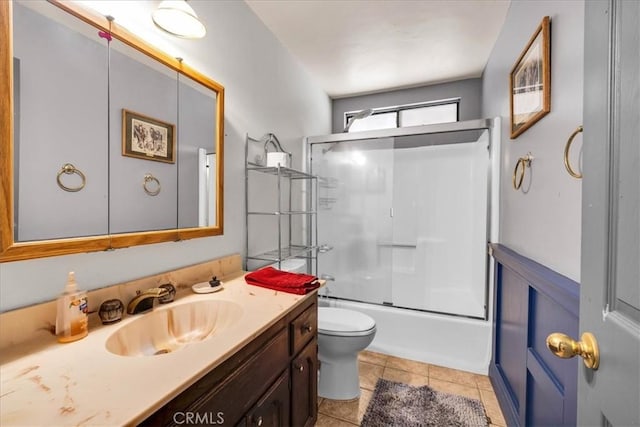 full bathroom with vanity, toilet, enclosed tub / shower combo, and tile patterned floors