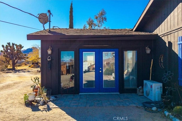 view of exterior entry featuring french doors and a patio