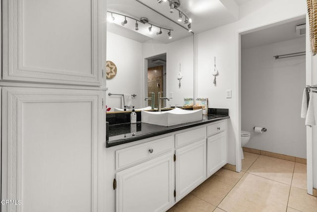 bathroom featuring vanity, toilet, and tile patterned flooring