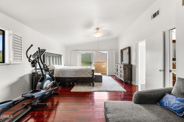 bedroom with lofted ceiling, dark hardwood / wood-style floors, and multiple windows