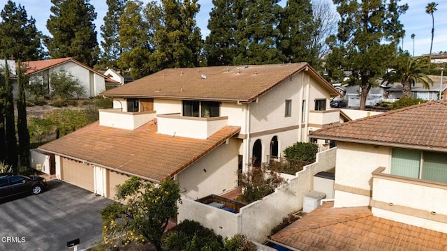 rear view of property featuring a garage