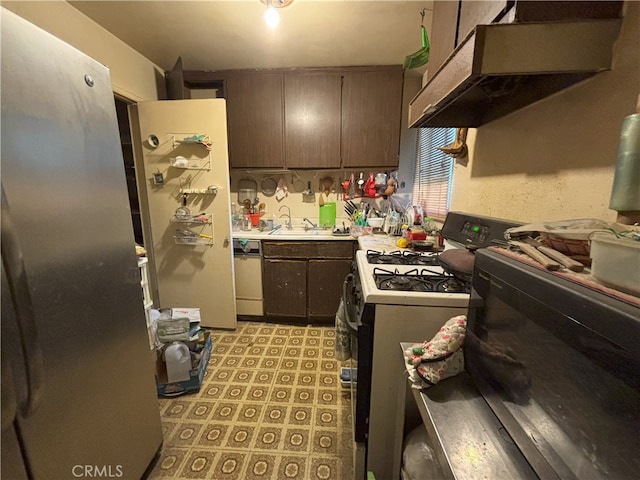 kitchen featuring sink, white appliances, and dark brown cabinetry