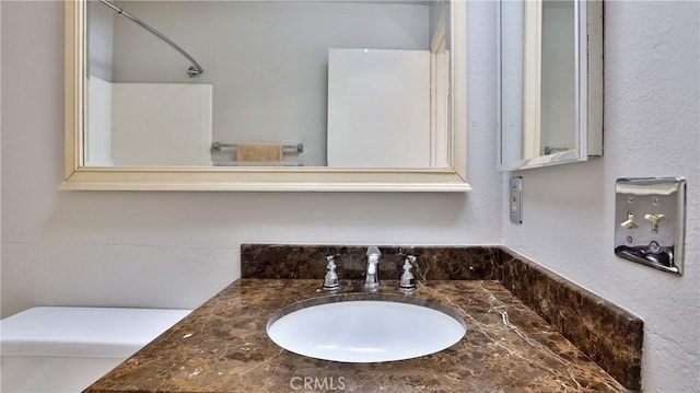 bathroom featuring vanity and toilet