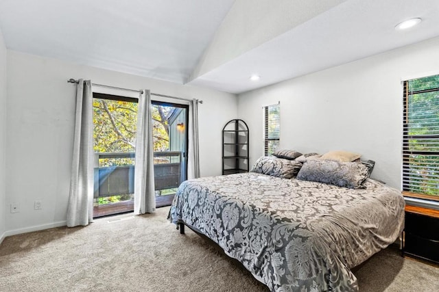 bedroom with lofted ceiling and light carpet