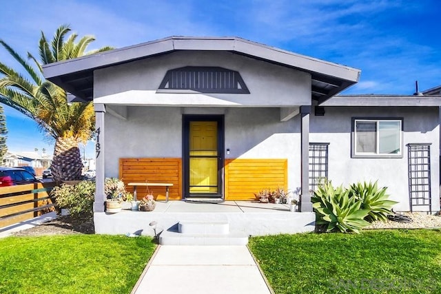 doorway to property with a yard