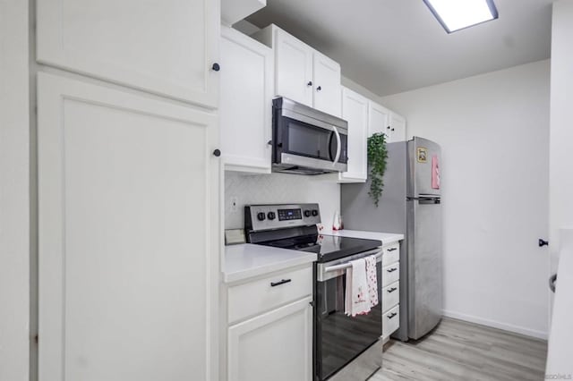 kitchen with white cabinetry, light hardwood / wood-style flooring, and appliances with stainless steel finishes