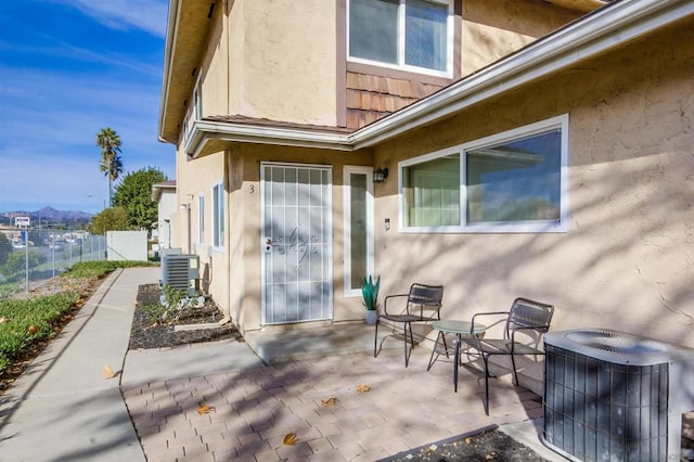 exterior space with cooling unit and a patio