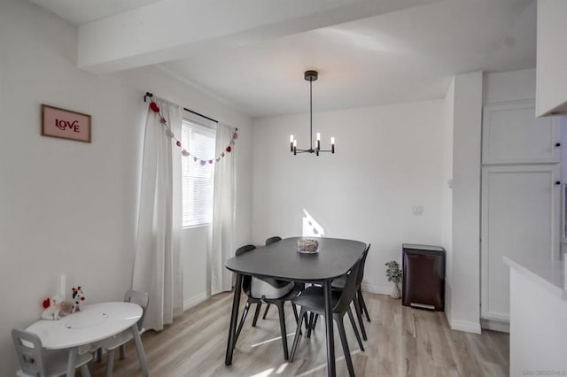 dining room with an inviting chandelier and light hardwood / wood-style floors