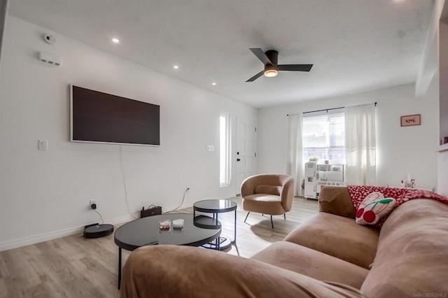 living room featuring ceiling fan and light hardwood / wood-style flooring