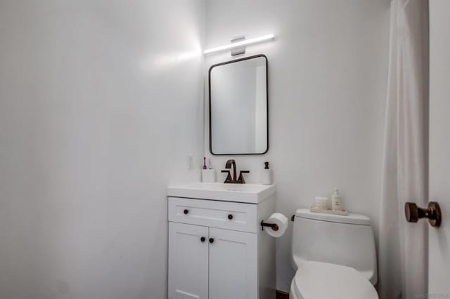 bathroom with toilet and vanity